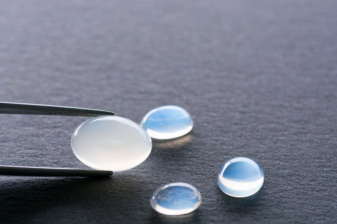 Blue moonstone gemstone and whitish moonstone with luminous blue sheen, reflecting moonstone meaning and spiritual energy
