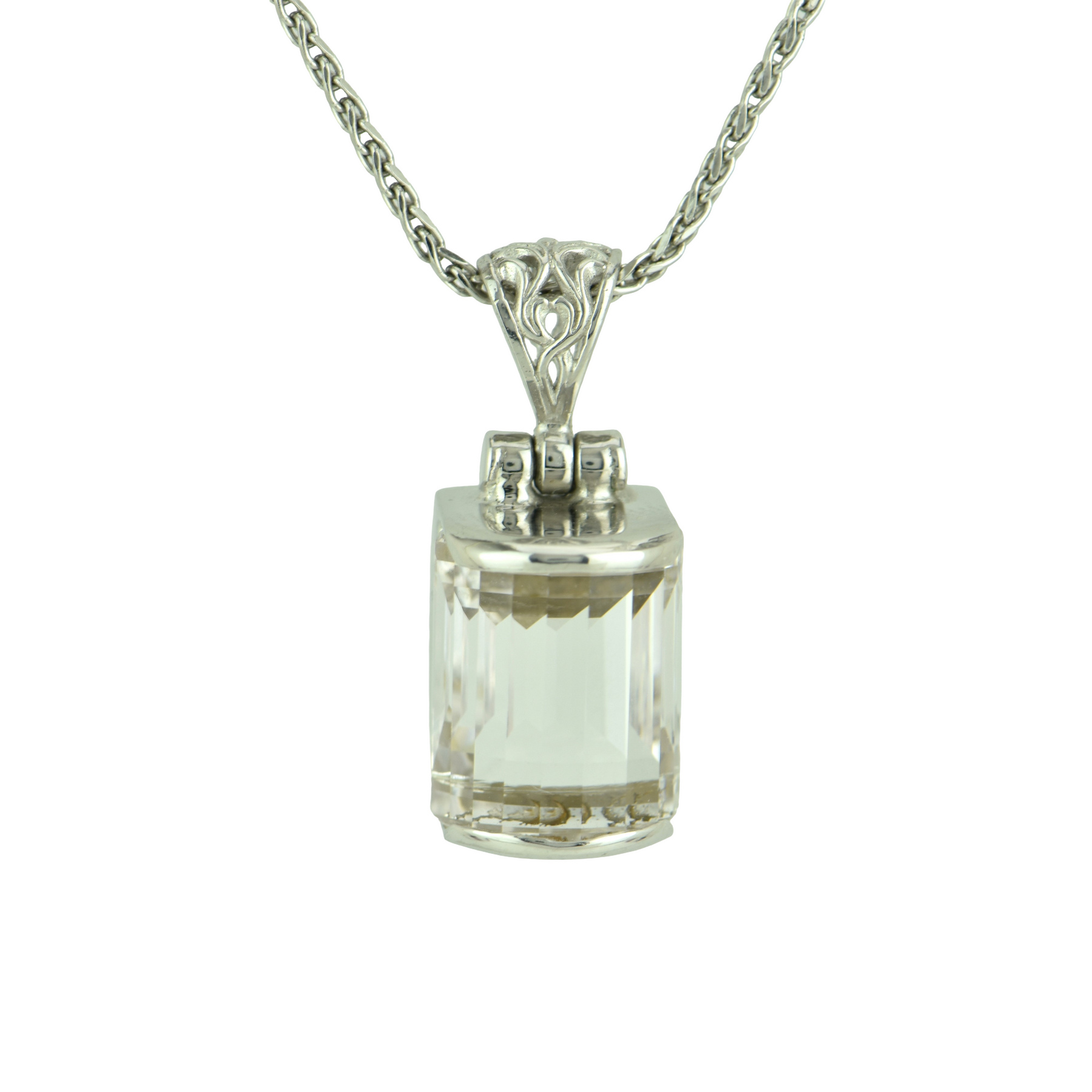 Emerald cut white sapphire pendant set in sterling silver with a filigree bail on a wheat chain